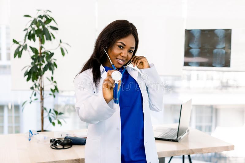 cute-afro-american-doctor-her-office-holding-stethoscope-standing-light-office-clinic-cute-afro-american-doctor-her-160216993